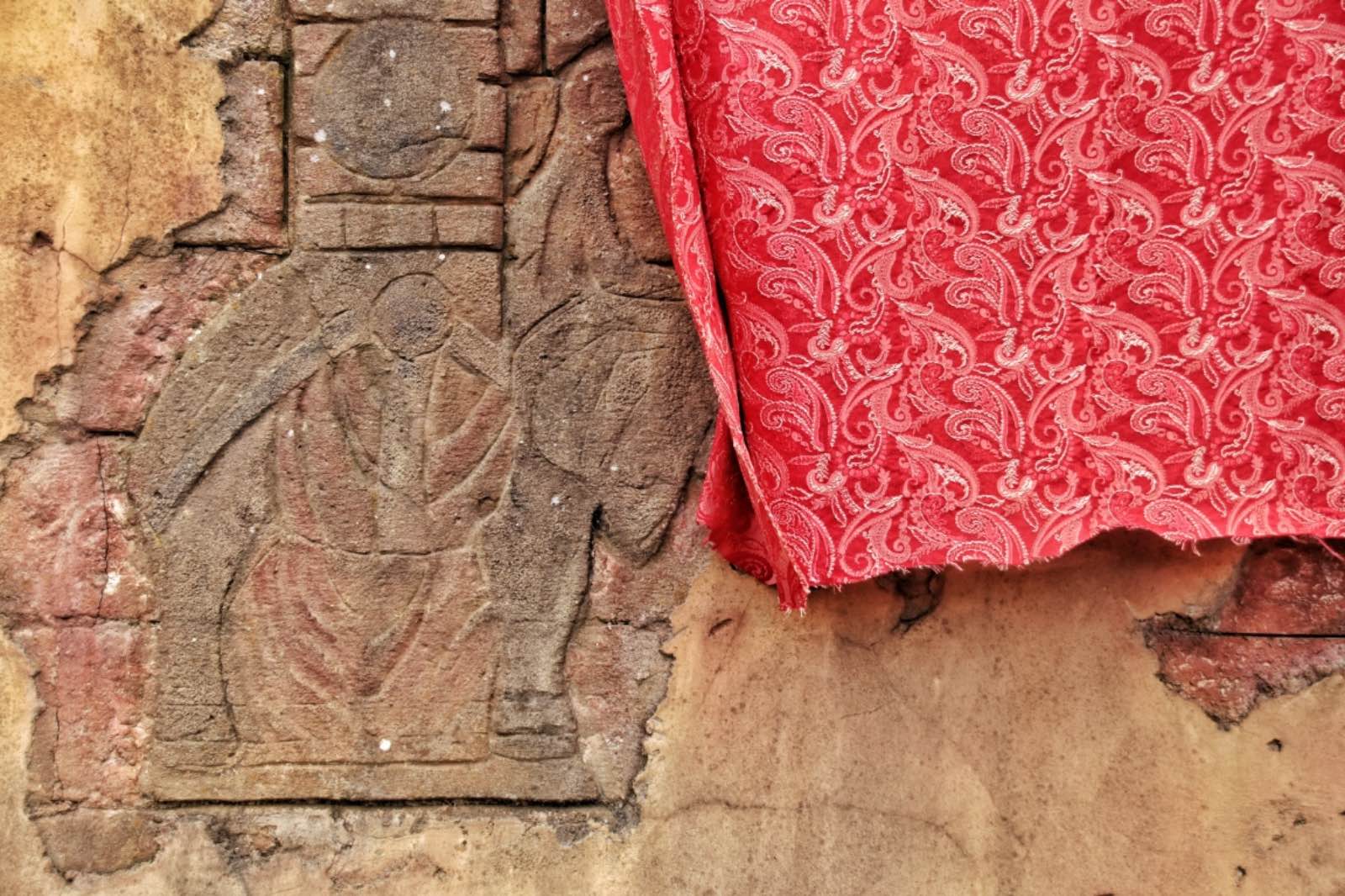 Indian fabric hung over a wall to dry